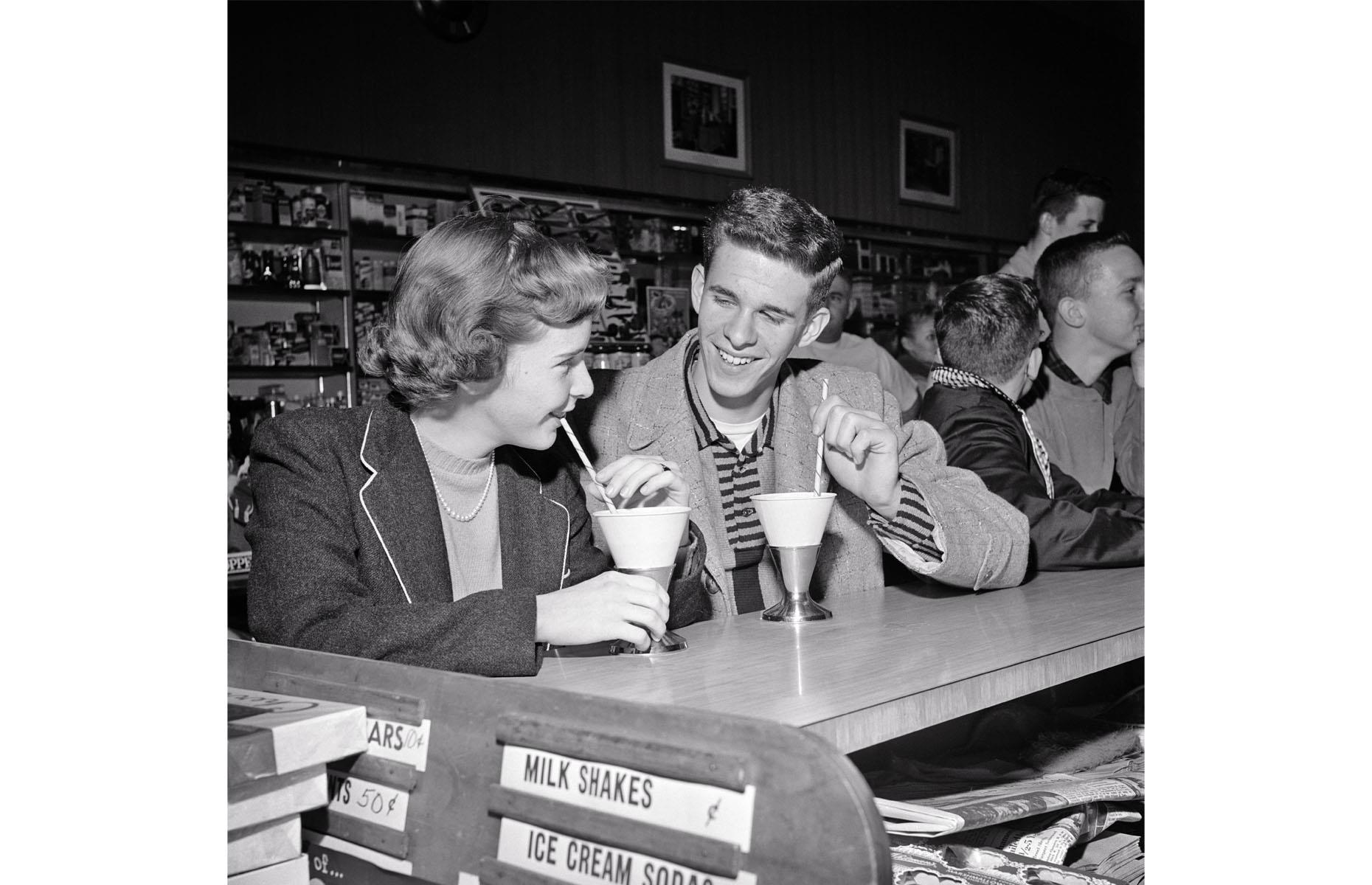 Teenage couple in a malt shop, 1950s